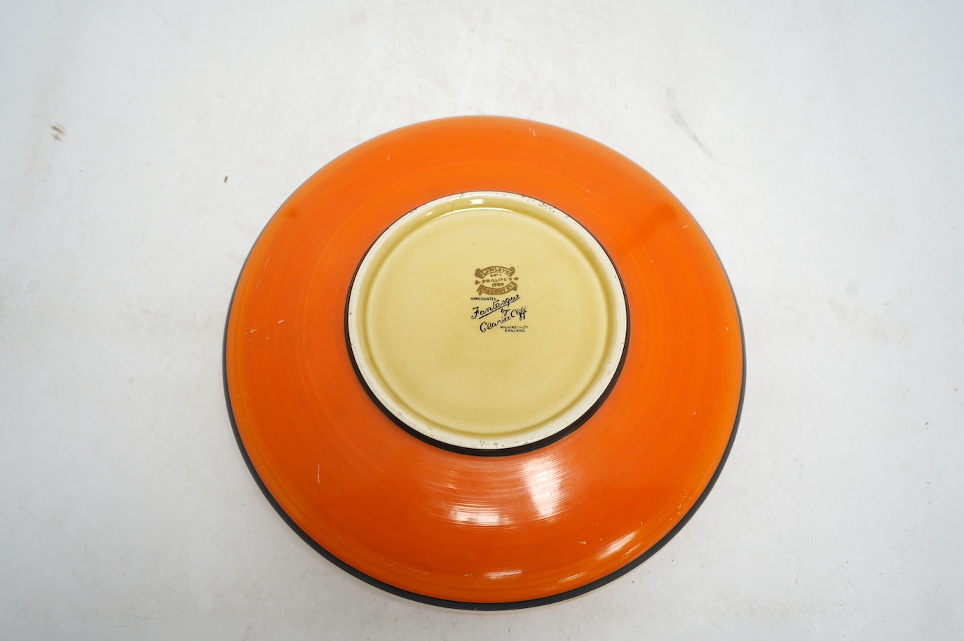 A Clarice Cliff Fantasque shallow dish, 24cm in diameter. Condition - fair
